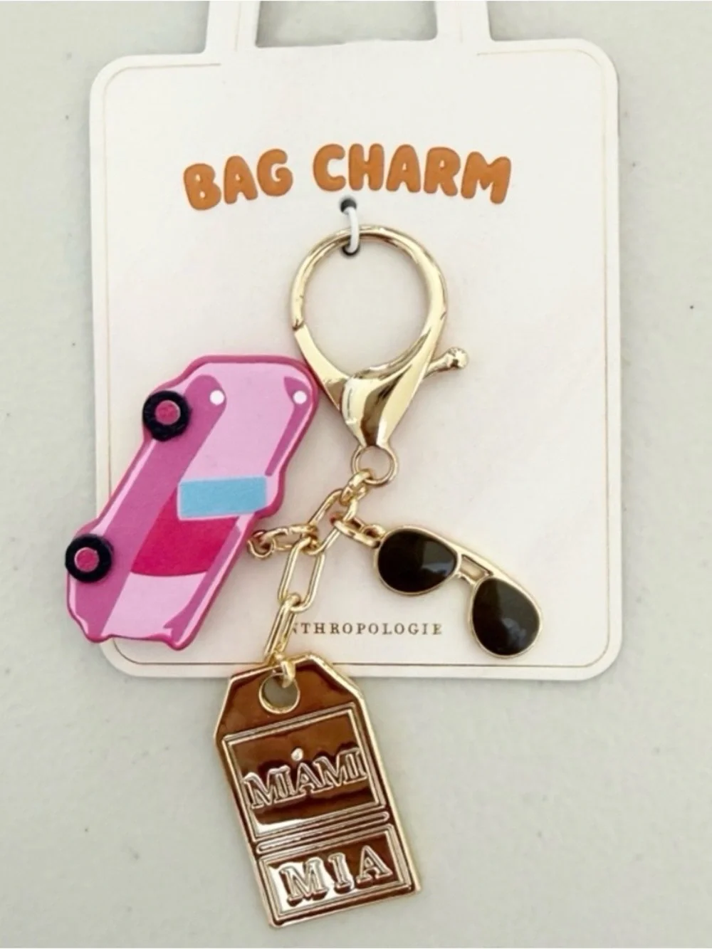 Anthropologie Miami city bag charm pink enamel car gold tag key charm NWT